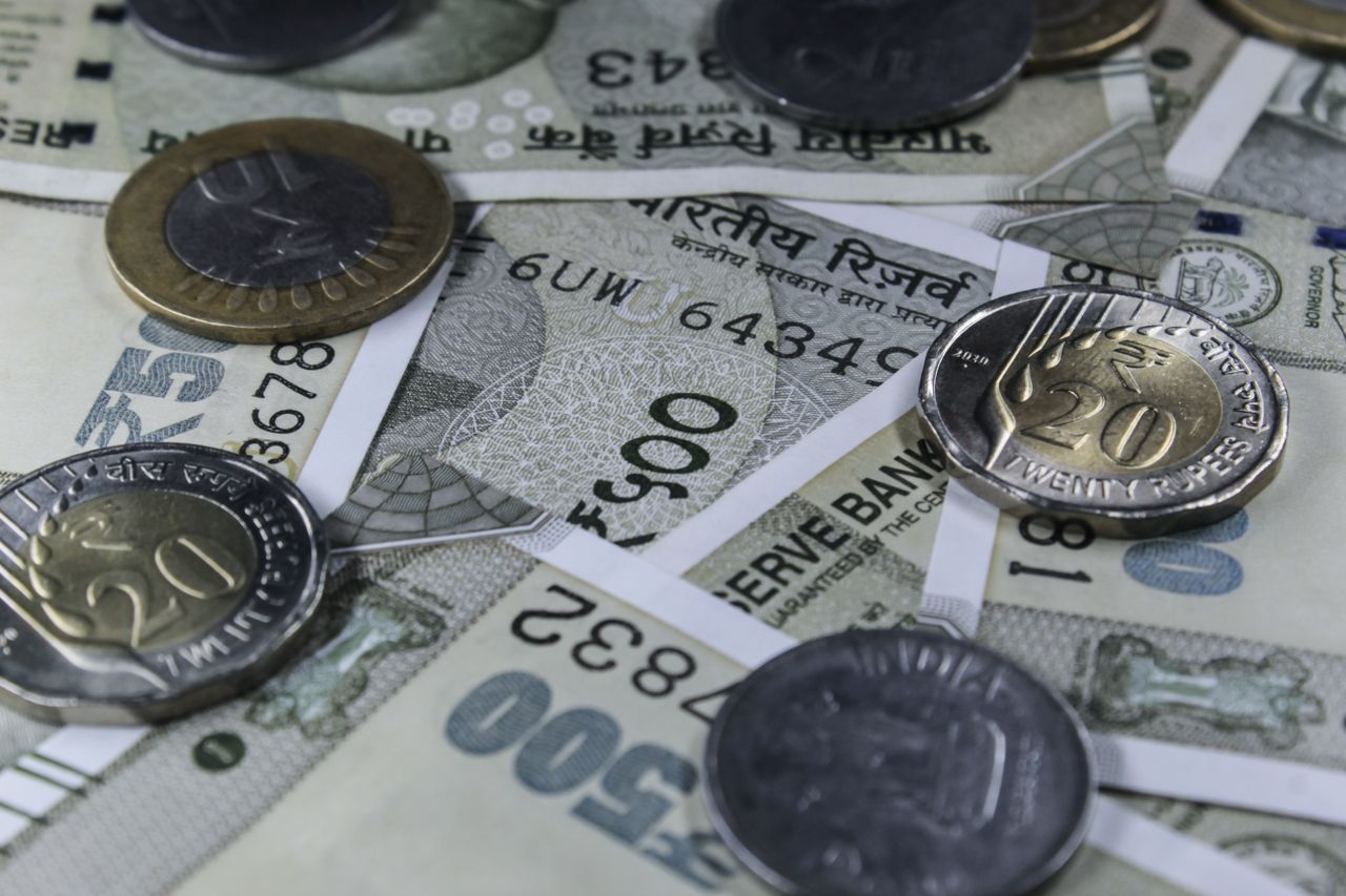 heros-img Detailed view of Indian rupee banknotes and coins, showcasing currency variety.